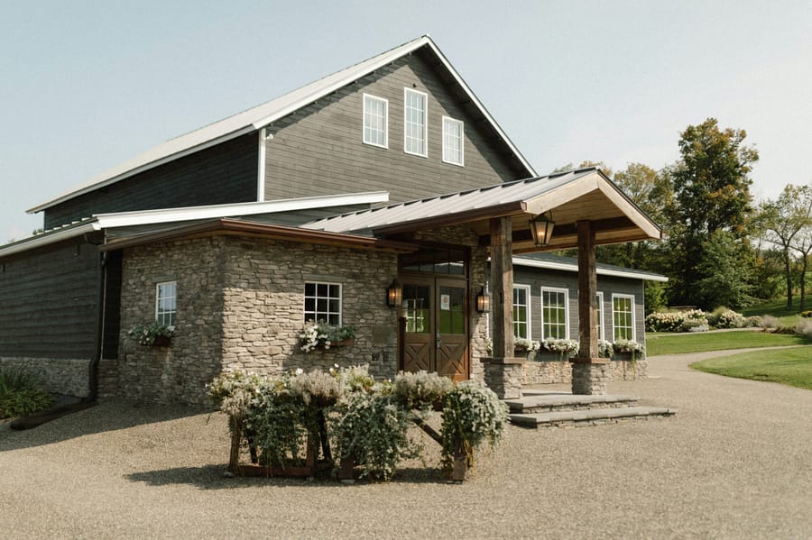 A welcoming senior living community with stone-and-timber architecture and flower gardens